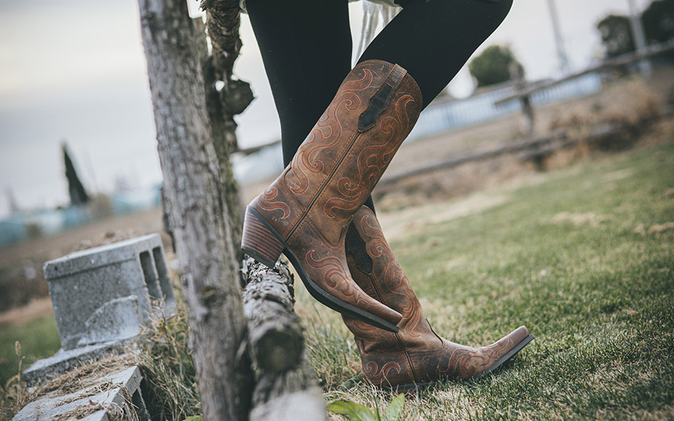 A Stylish Fusion Of Riding Boots And Trench Coat